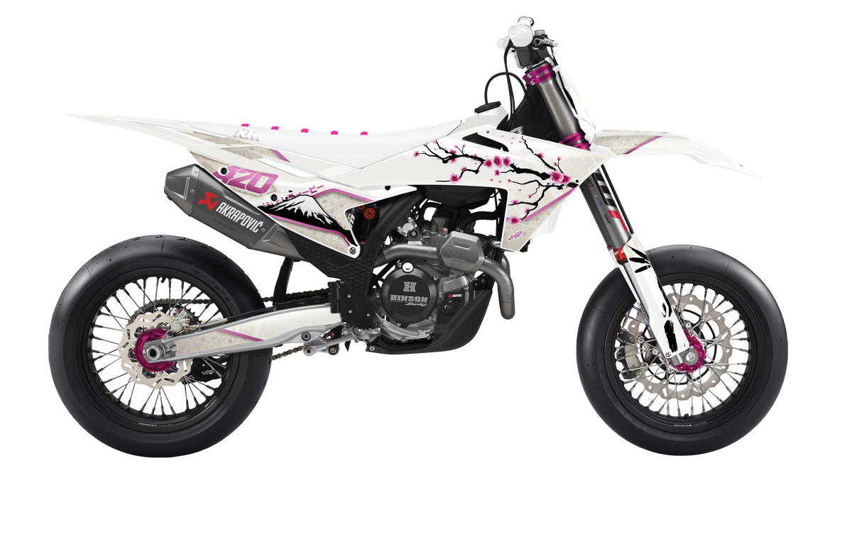 A white and black dirt bike with pink cherry blossom graphics, featuring a black exhaust and silver wheels, shown from a side profile on a white background.